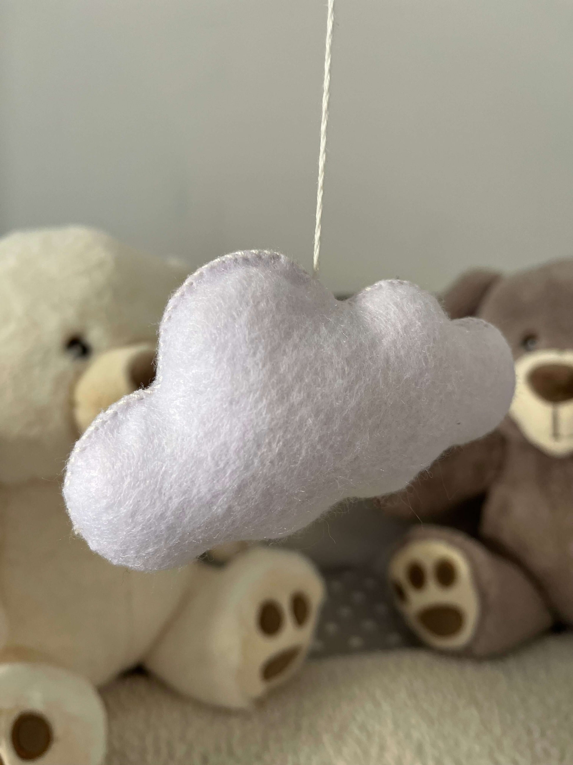Cute felt cloud mobile designed to inspire peace and faith in children's nurseries.