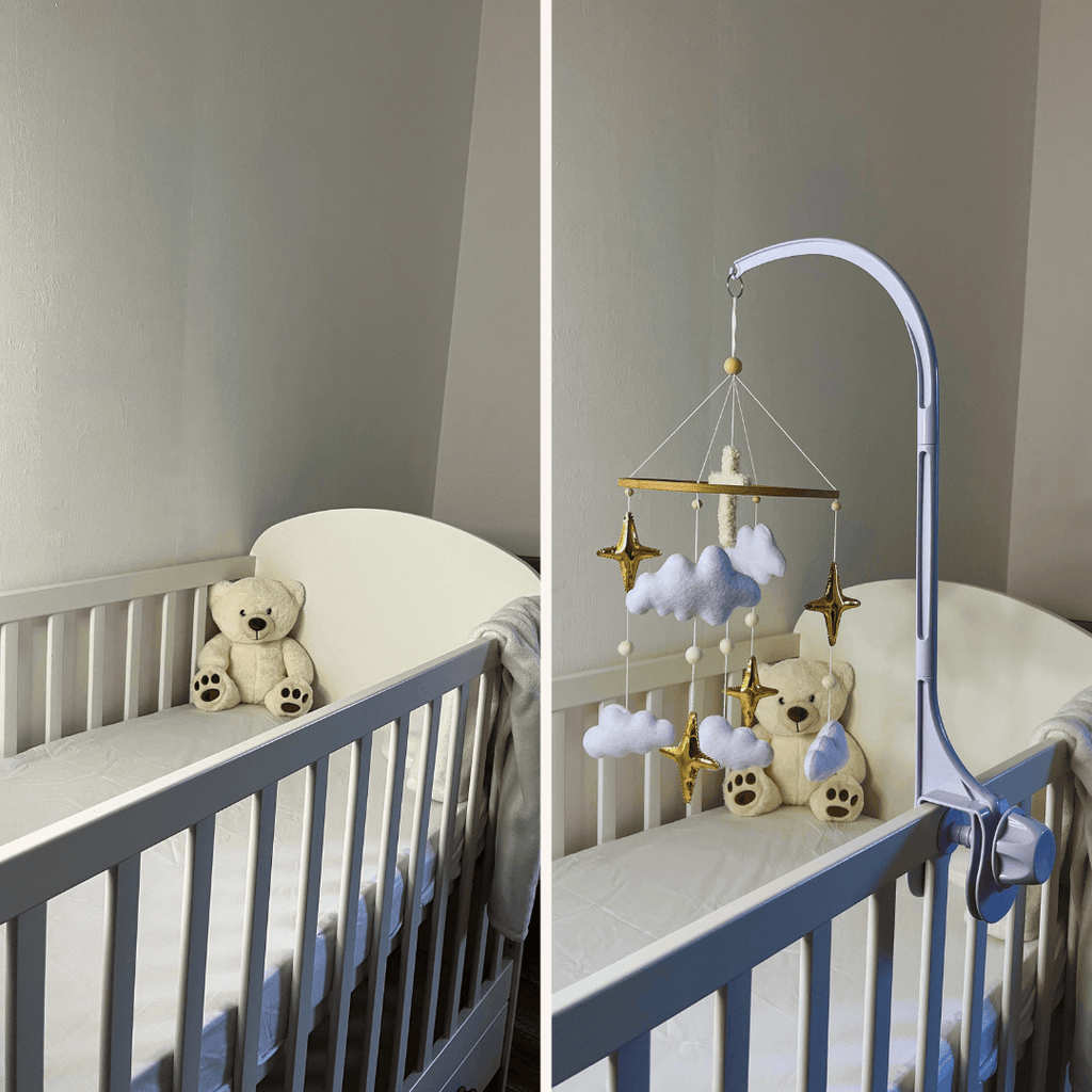 White crib featuring a teddy bear and a mobile with clouds and stars for soothing infant relaxation.