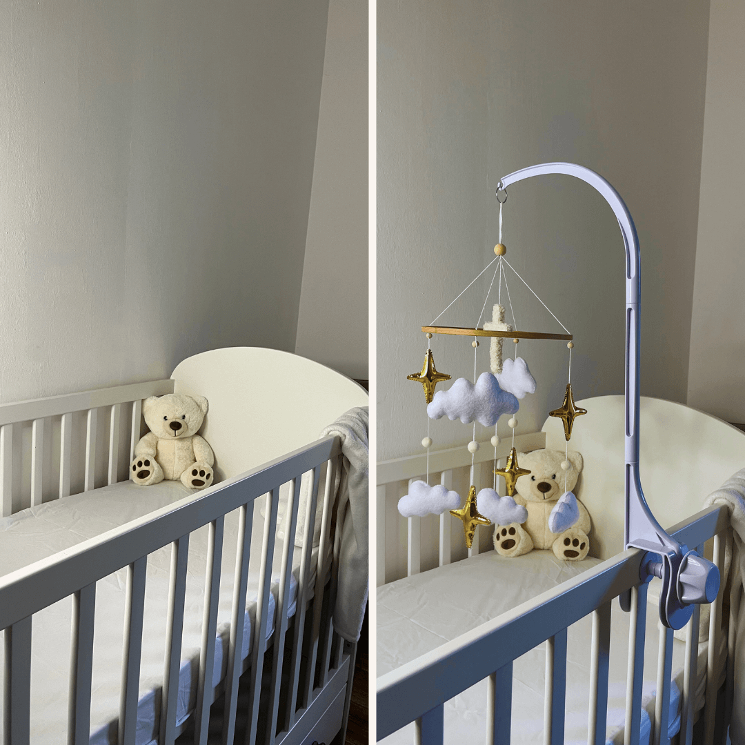 White crib featuring a teddy bear and a mobile with clouds and stars for soothing infant relaxation.